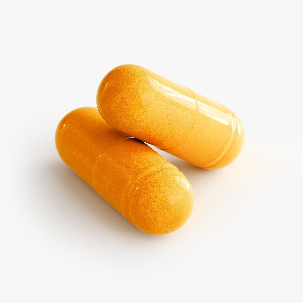 Two orange CoQ10 gelatin capsules on a white background